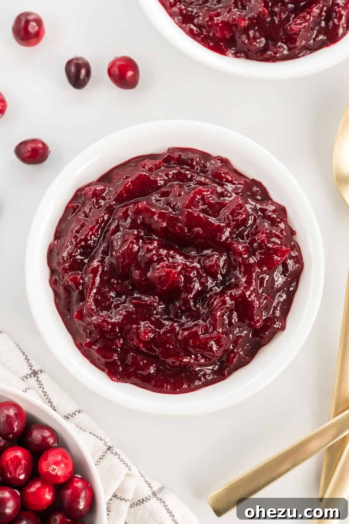 Crafted Cranberry Bliss 2 A beautiful white bowl filled with glistening homemade cranberry sauce, ready to be served at Thanksgiving dinner.