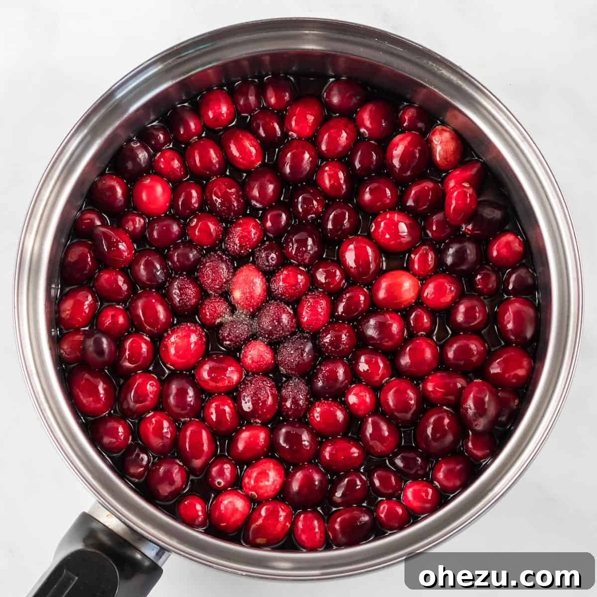 Crafted Cranberry Bliss 4 Fresh cranberries, maple syrup, and salt are added to a medium saucepan, ready for cooking into delicious cranberry sauce.