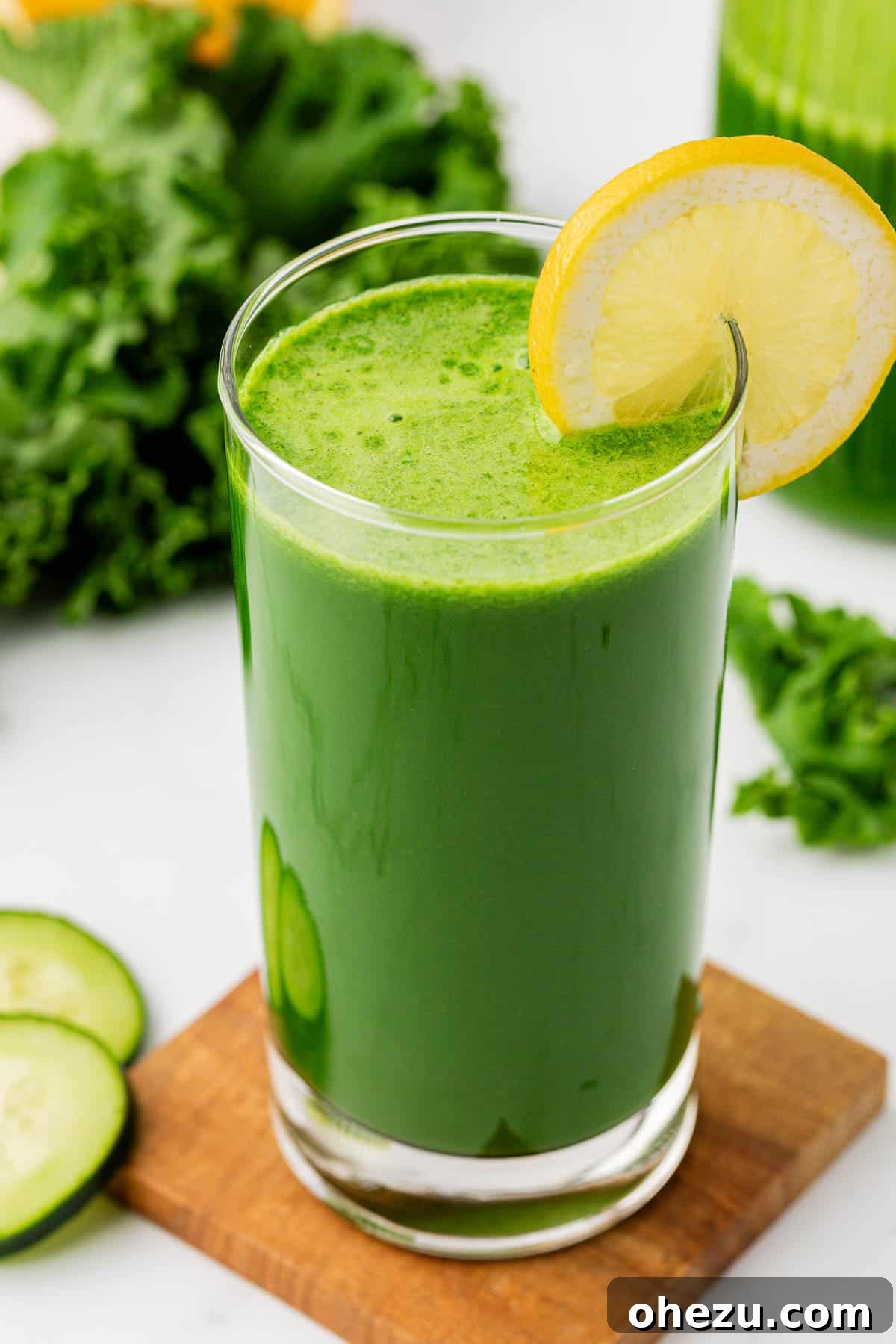 kale juice in a glass with a lemon slice on the rim