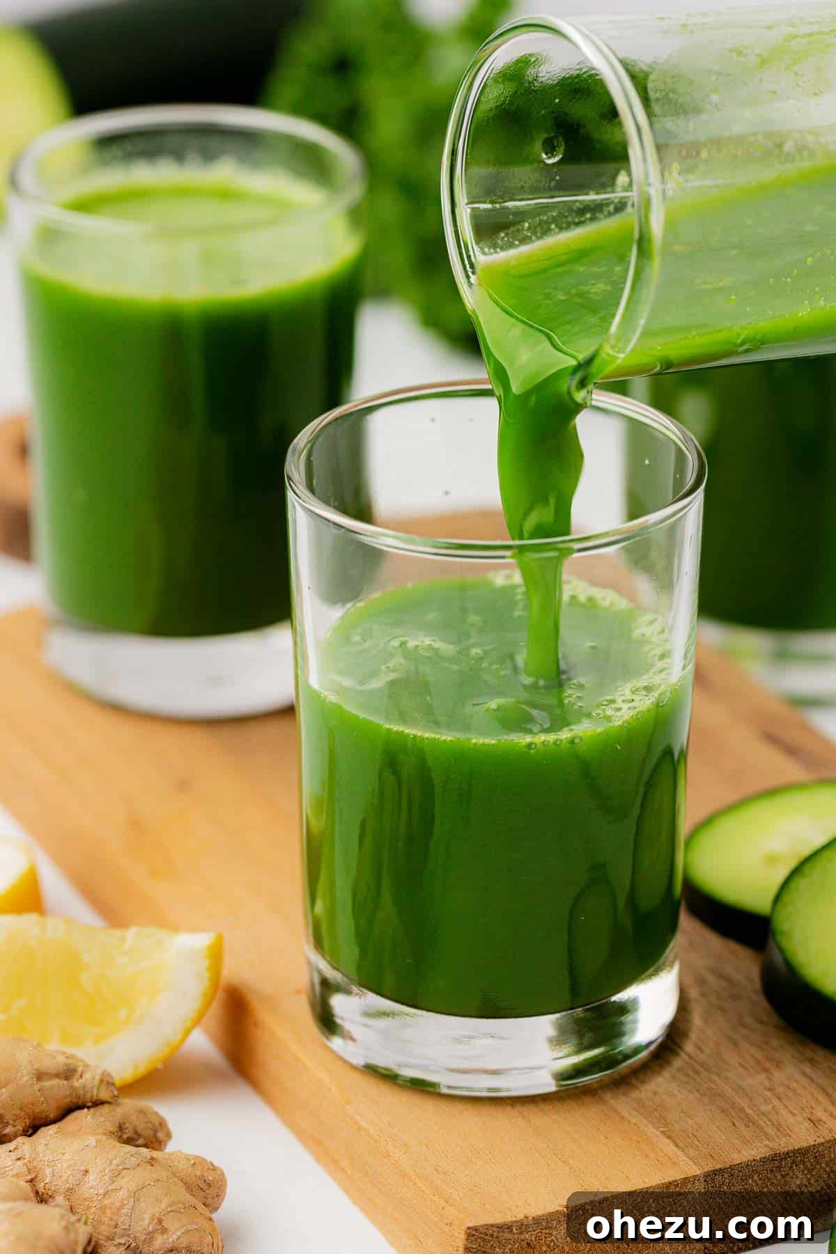 pouring green juice into a glass