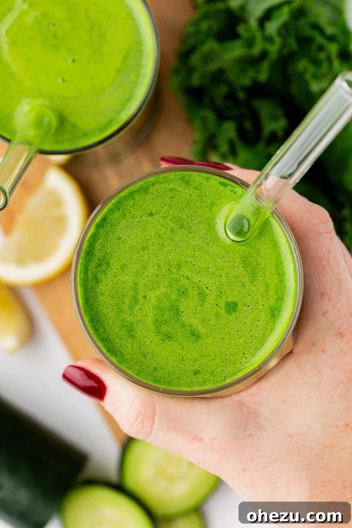 kale juice in a glass with a straw