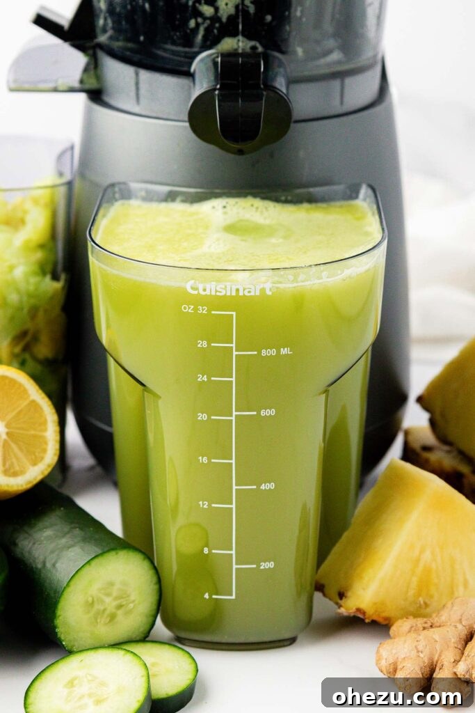 Freshly extracted pineapple cucumber juice collecting in a juicing canister