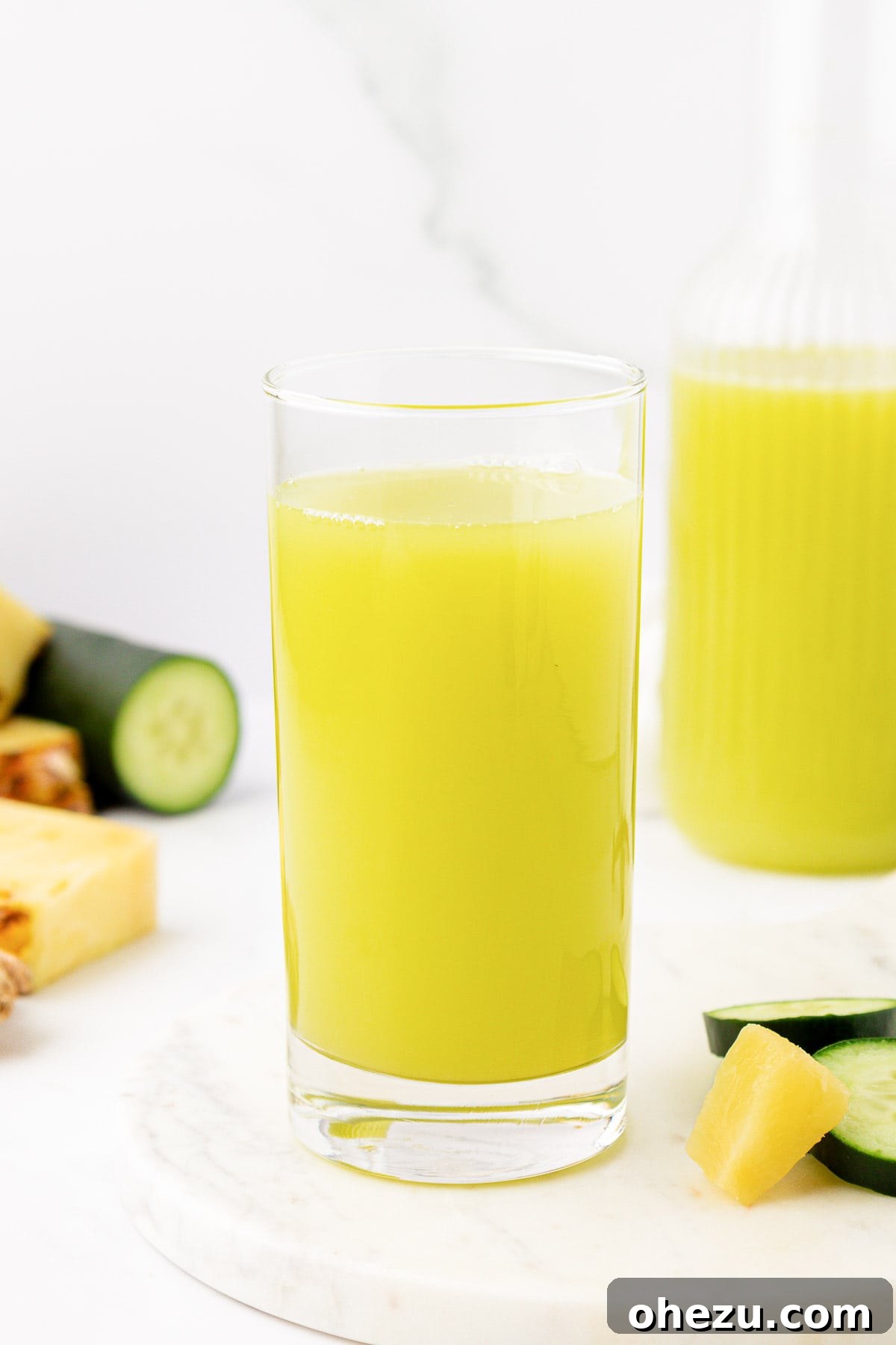 A glass of pineapple cucumber juice, perfectly chilled and ready to drink