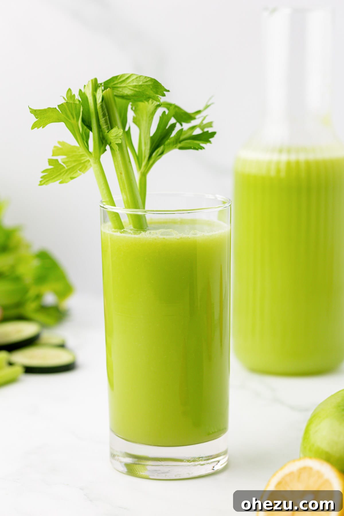 celery juice in a glass with a celery stalk garnish