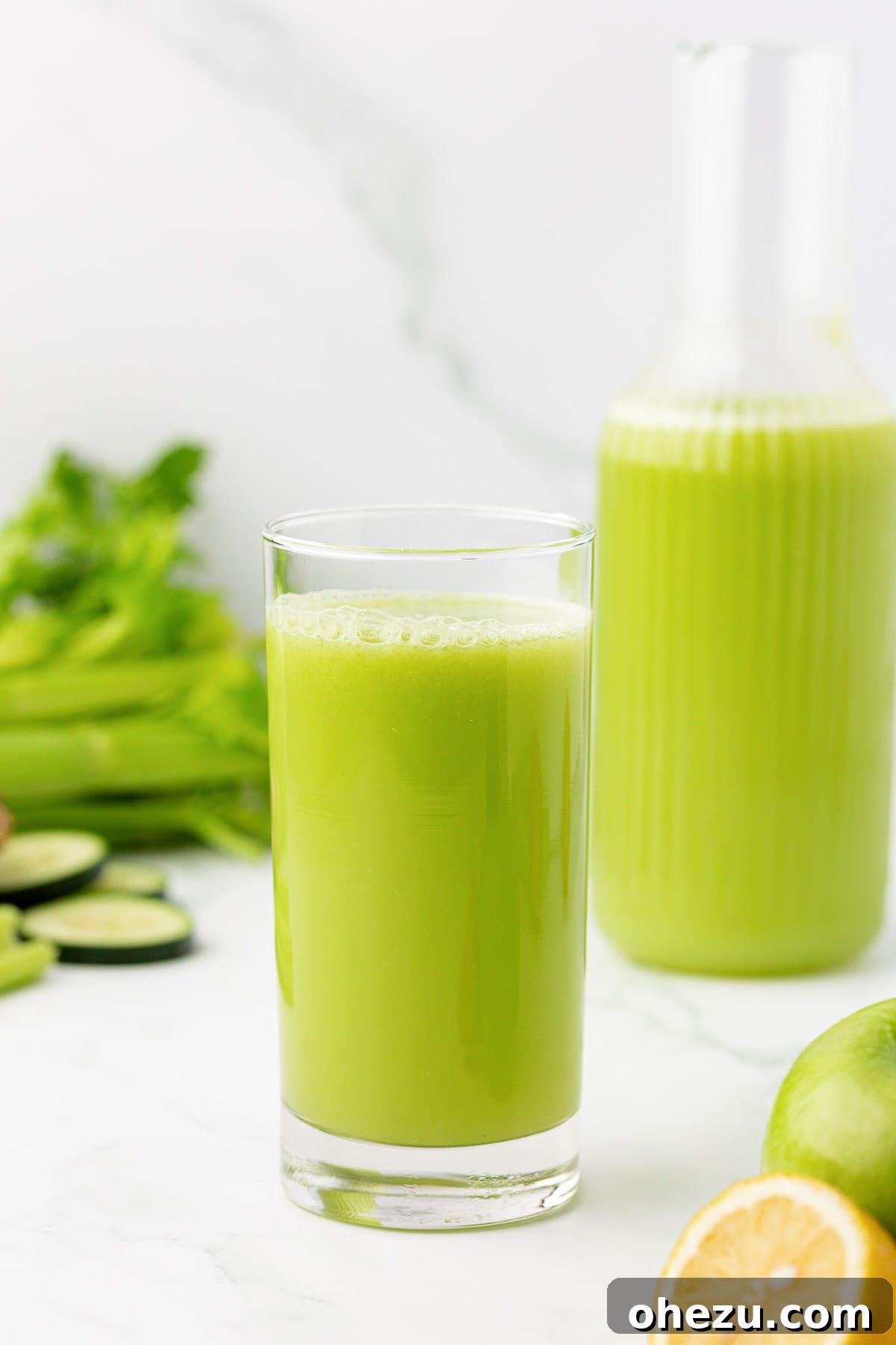 celery juice in a clear glass on a wooden surface