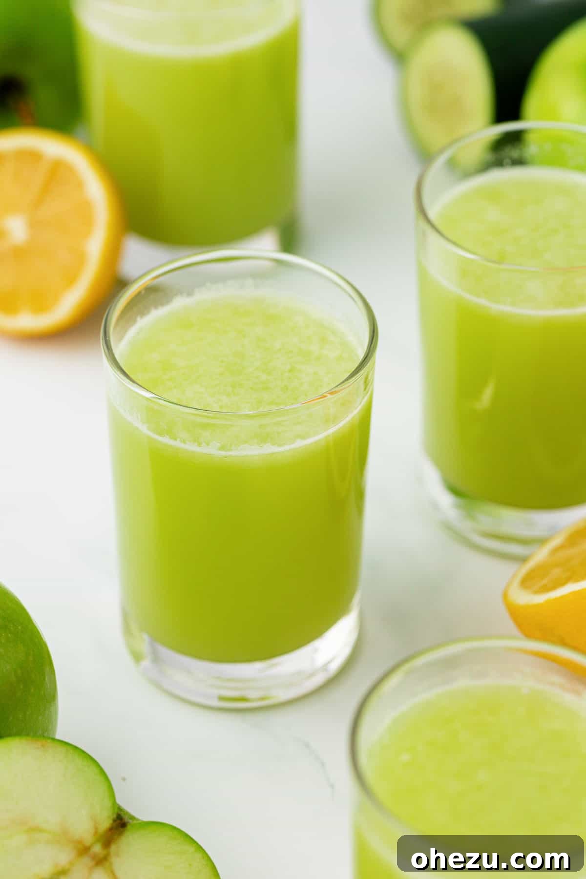 A single glass of vibrant green apple juice, placed aesthetically on a surface