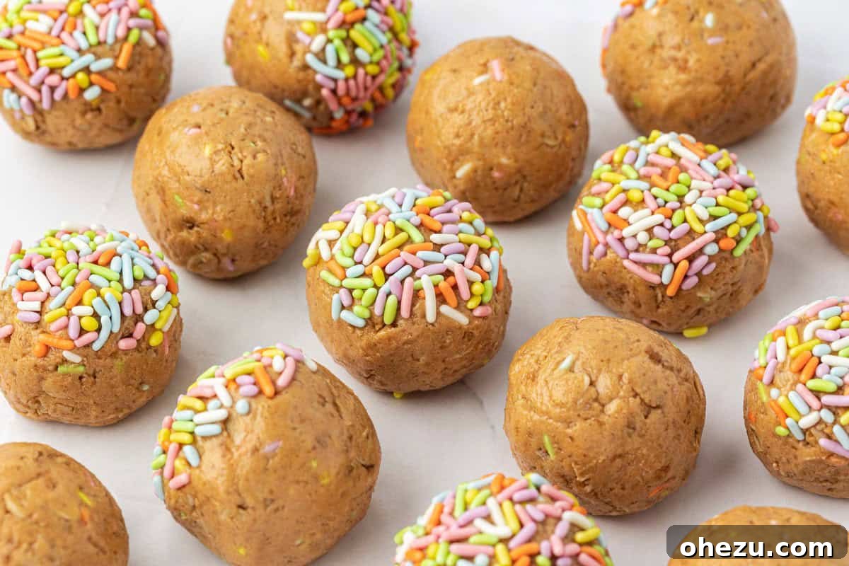 A close-up of Birthday Cake Protein Balls in a bowl, showing the texture and colorful sprinkles.