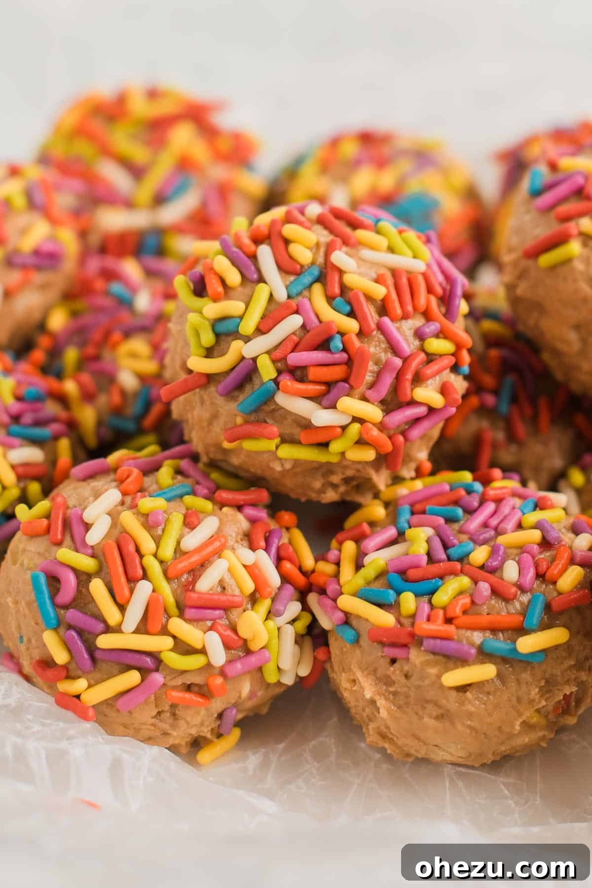A large pile of Birthday Cake Protein Balls on a baking sheet, showcasing their festive appeal and readiness for enjoyment.
