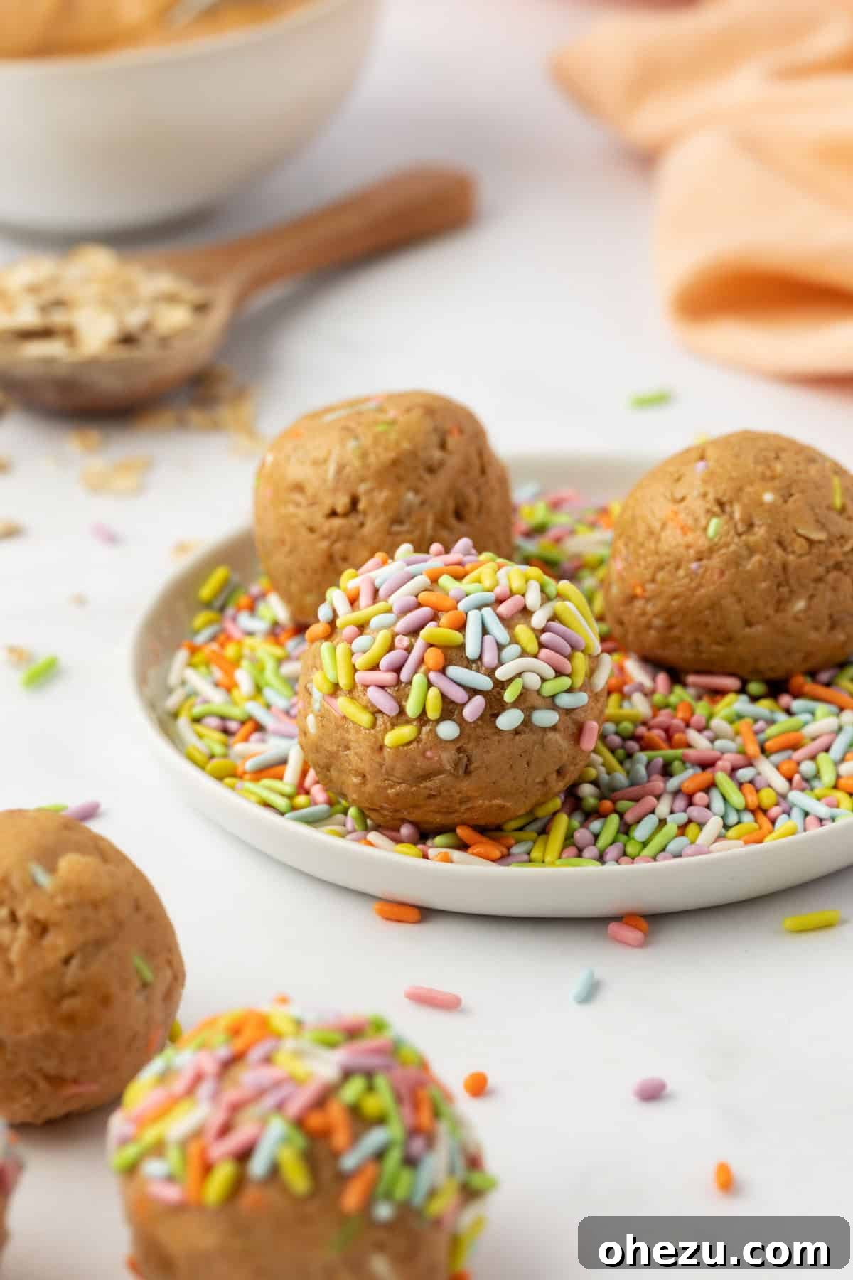 A stack of Birthday Cake Protein Balls presented beautifully, showing off their colorful sprinkles and inviting texture.