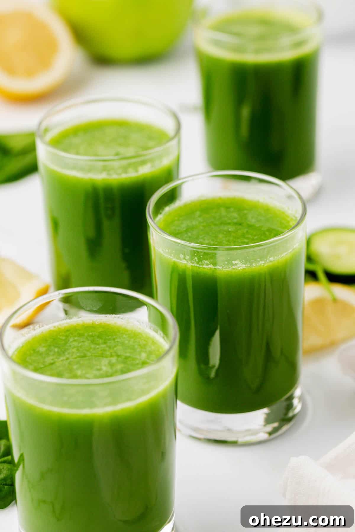 Green Vitality Boost 11 A tall glass of vibrant spinach juice, garnished with a spinach leaf and a slice of green apple, ready to be enjoyed.
