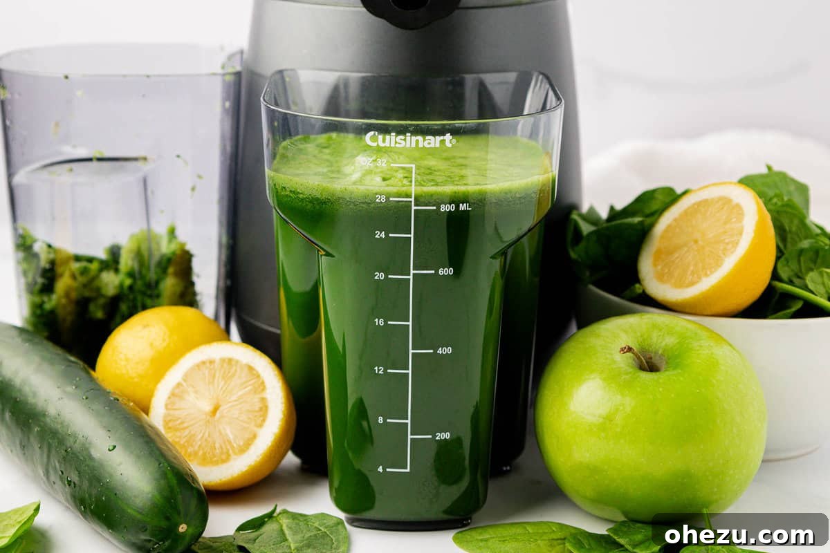 Green Vitality Boost 3 Freshly juiced spinach and other ingredients collected in the juicing canister, ready to be poured.