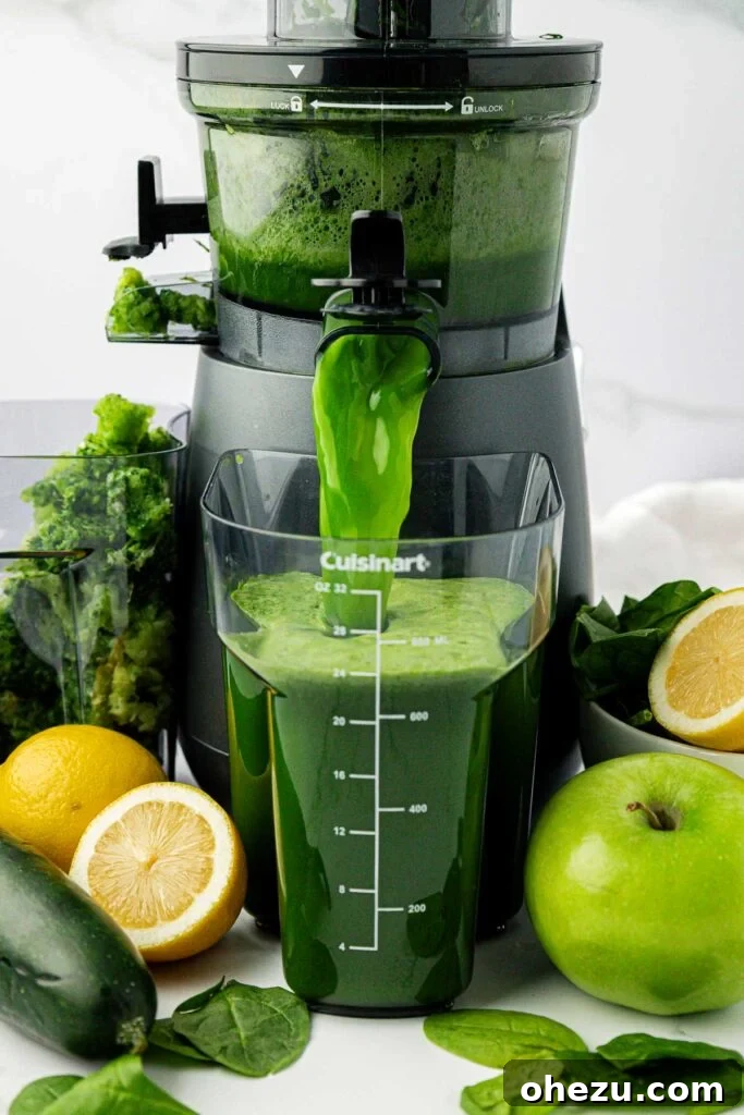 Green Vitality Boost 5 Spinach juice pouring out of a juicer into a collection pitcher, showing the vibrant green color.