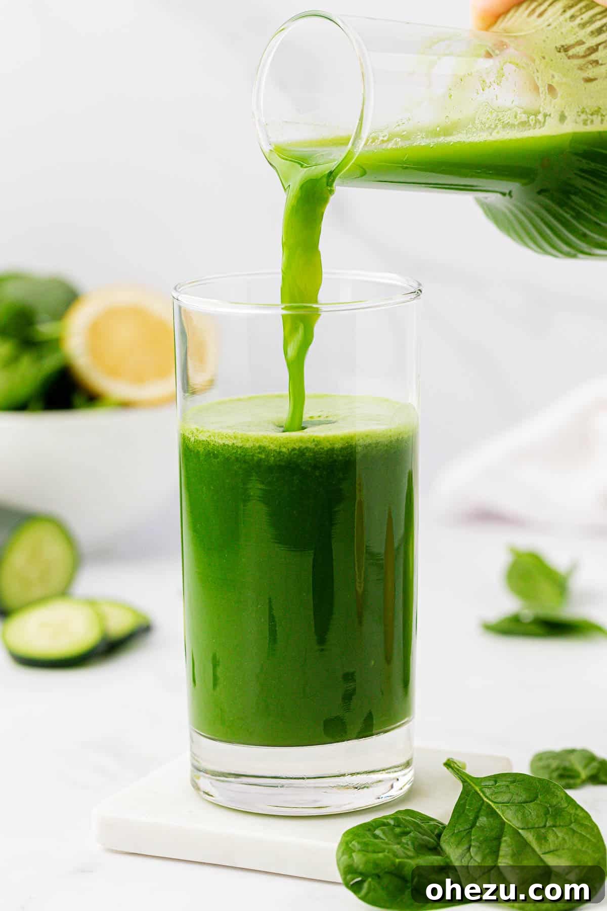 Green Vitality Boost 7 Pouring vibrant green spinach juice from a pitcher into a clear drinking glass.