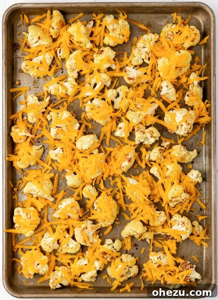 sprinkling shredded cheese over roasted cauliflower