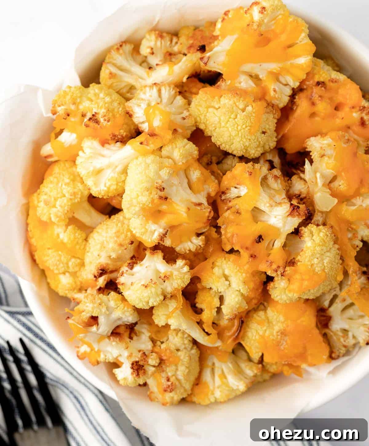 cheesy cauliflower served in a white serving bowl, ready to eat