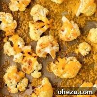 roasted cauliflower with cheese on a baking sheet