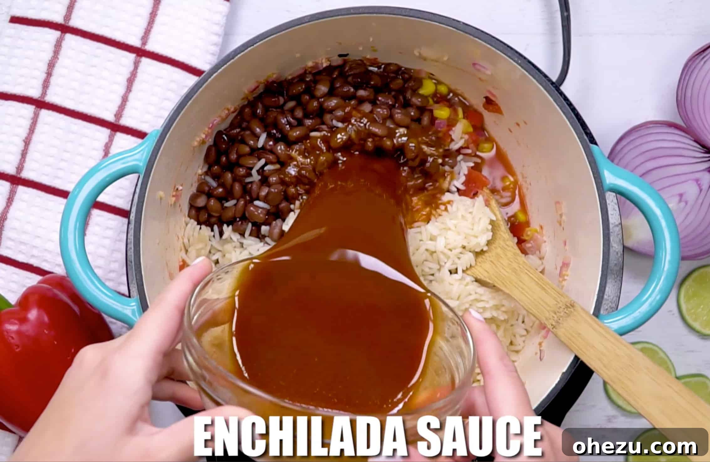 Fiesta Vegetarian Bake 11 Enchilada sauce being poured into the pan with rice, beans, and vegetables