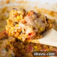 taking a scoop of mexican rice casserole from the dish