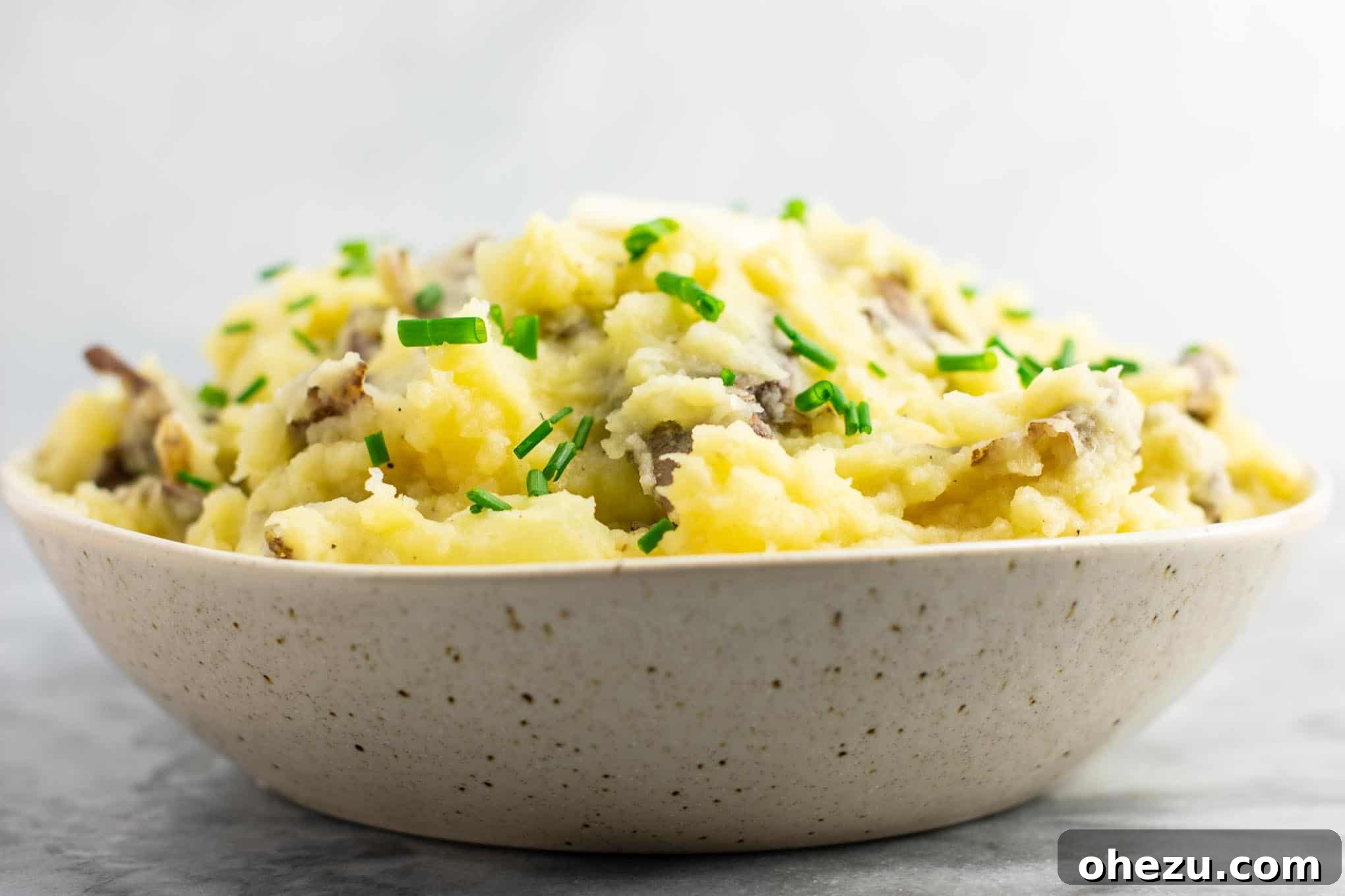 A large bowl of creamy vegan mashed potatoes, prepared and ready to be served.