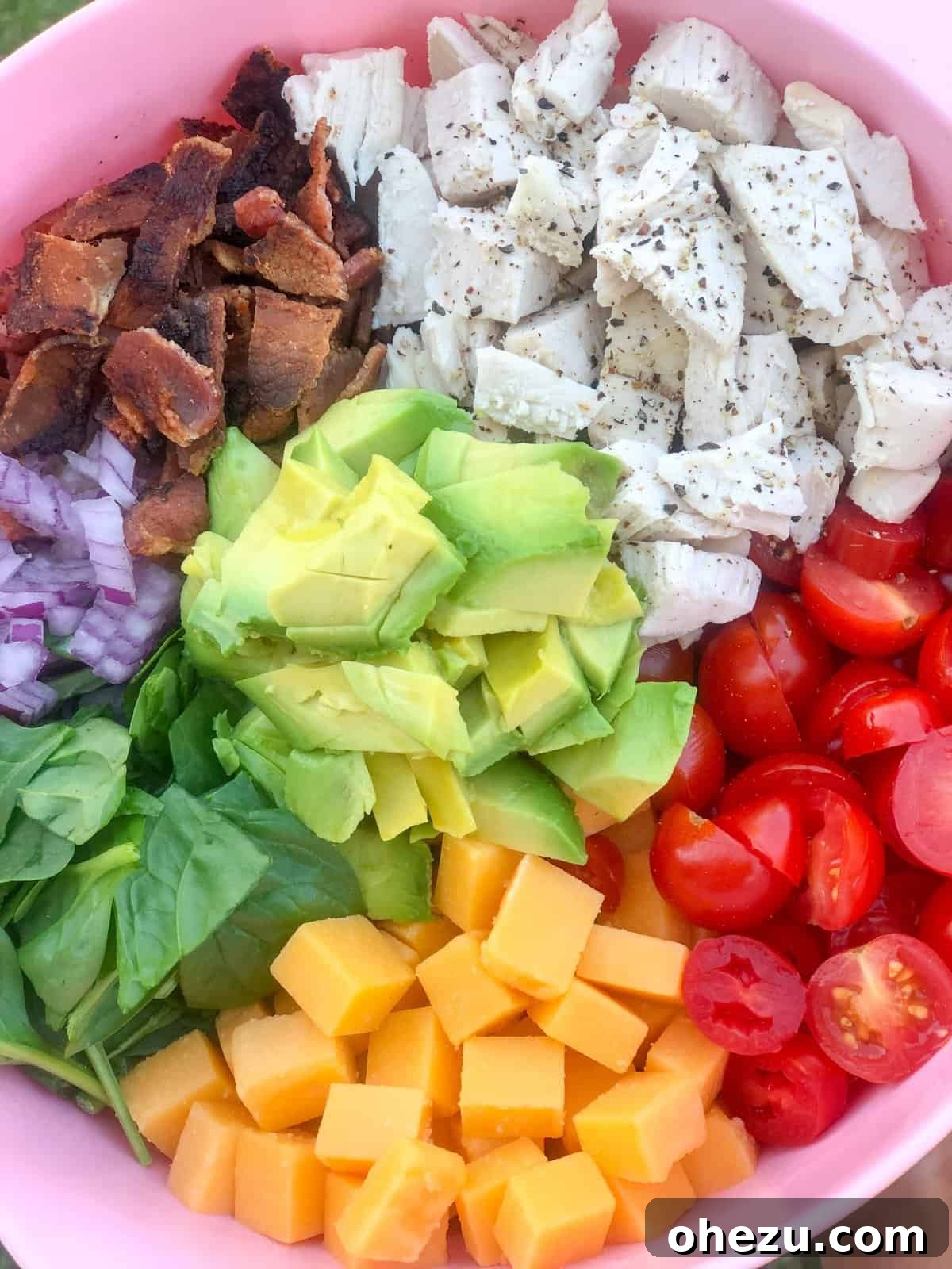 Creamy Avocado Chicken BLT Pasta Salad 5 A bowl of fresh ingredients for Chicken Avocado BLT Pasta Salad before mixing