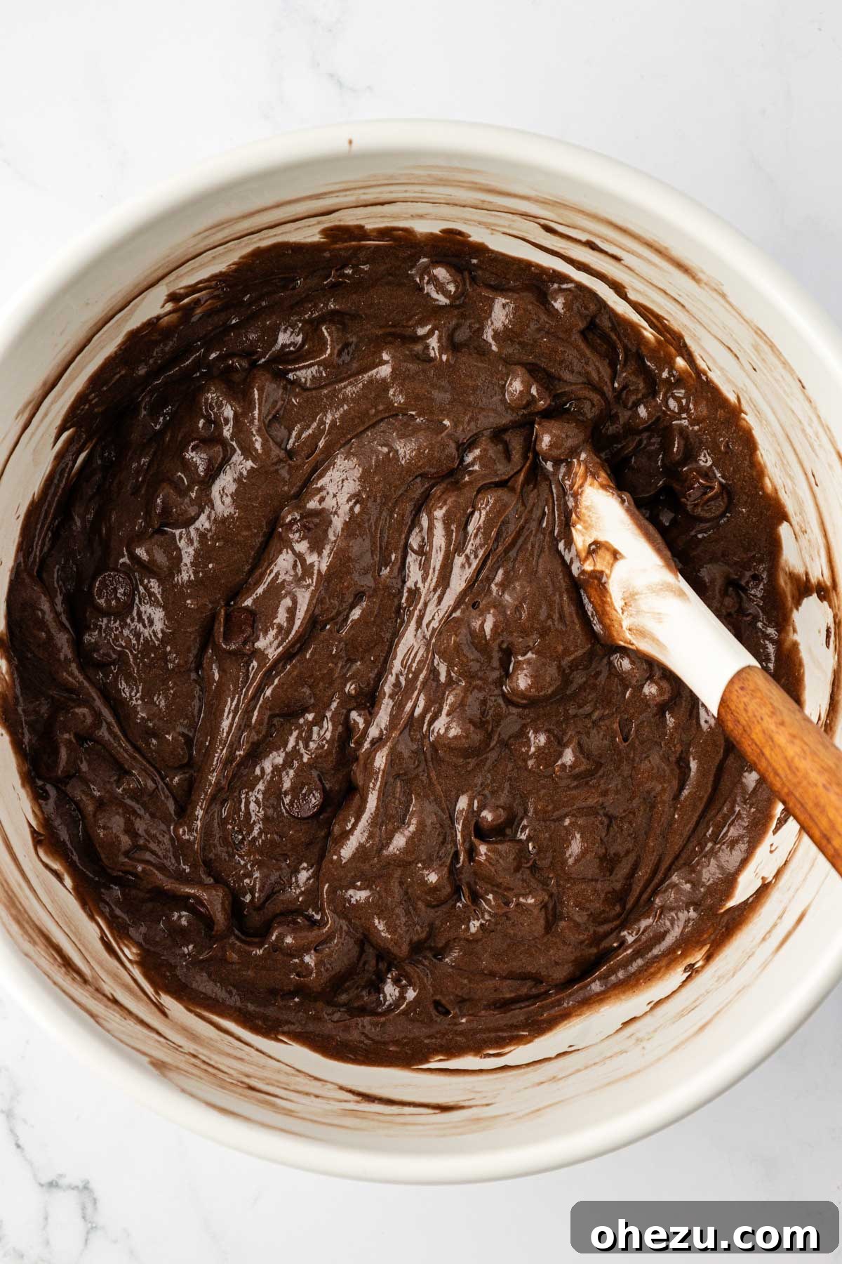 The final double chocolate cake mix muffin batter, perfectly mixed with chocolate chips, ready to be scooped.