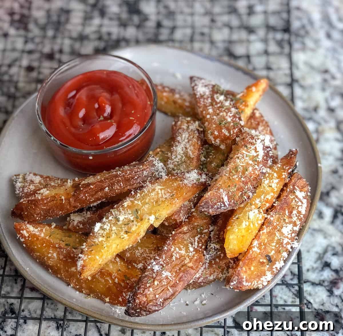 Ingredients laid out for Crispy Baked Oven Fries including potatoes, oil, and seasonings