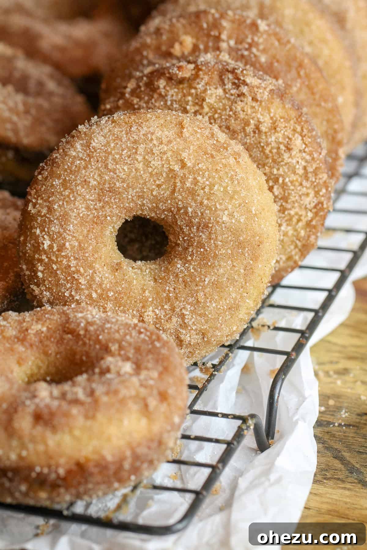 A close-up shot of a Caramel Apple Cider Donut with a visible caramel filling, highlighting its deliciousness.