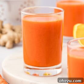 Glass of delicious carrot orange ginger juice