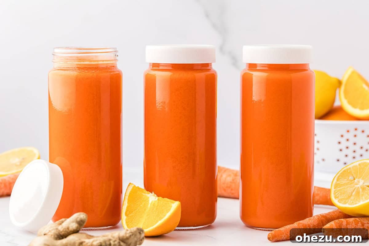 Multiple servings of carrot orange ginger juice stored in 16 oz glass jars with lids, ready for refrigeration.