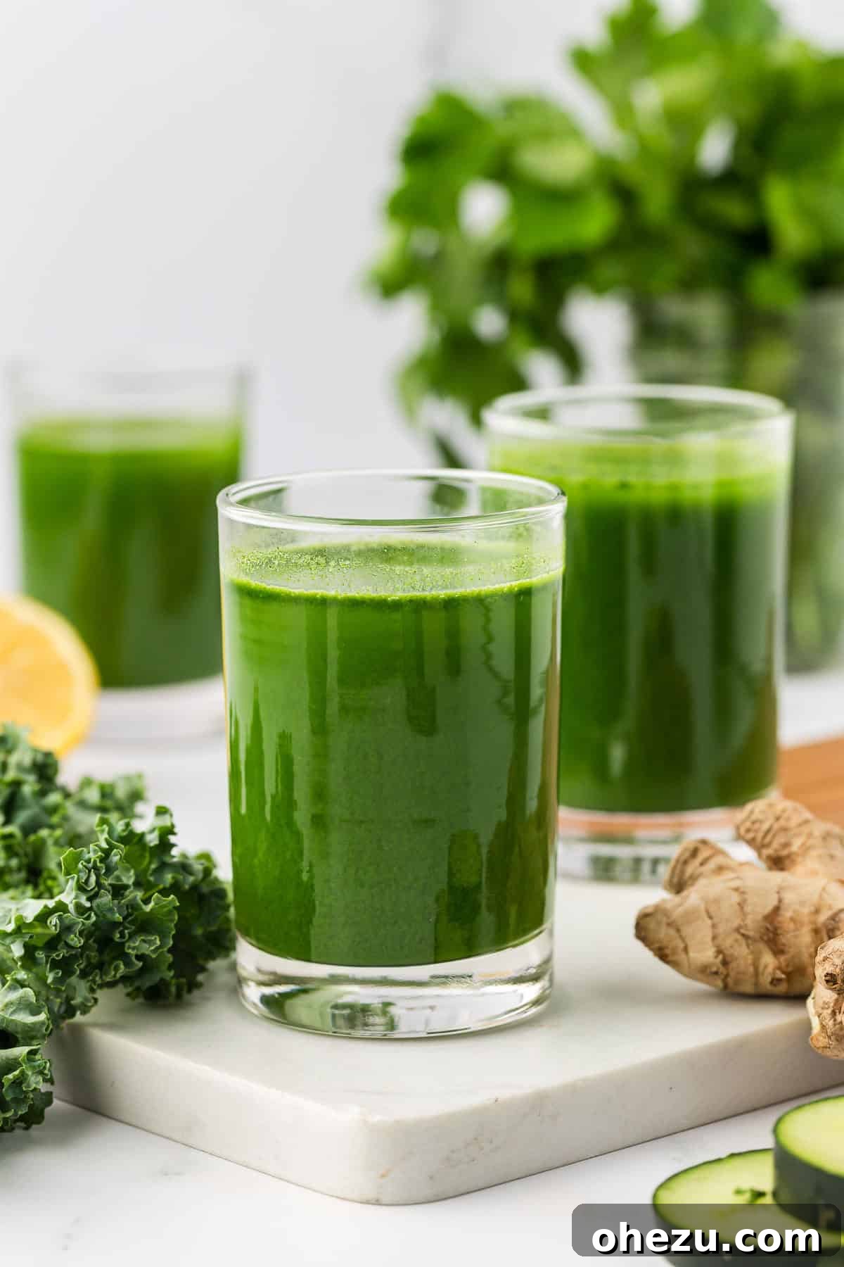 A refreshing glass of homemade vegetable juice with green apples in the background