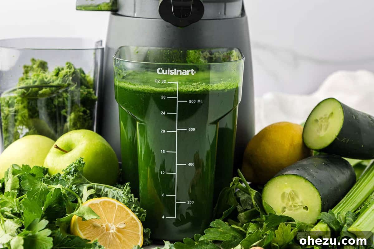 Freshly extracted green juice collecting in the juicer's pitcher