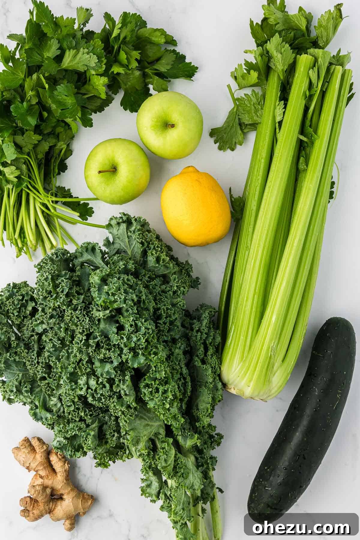 Fresh organic ingredients laid out on a wooden board, ready for making vegetable juice