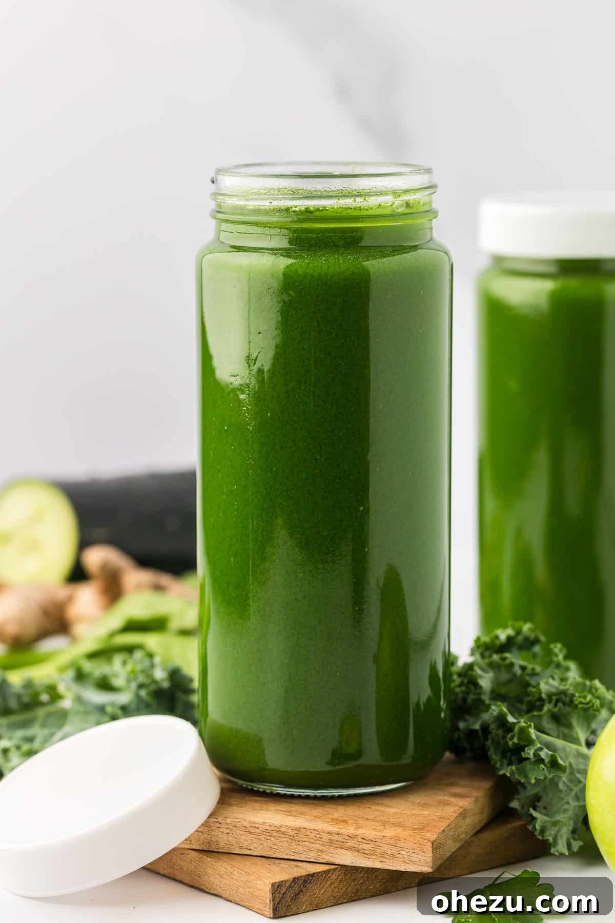 Stored vegetable juice in a clear glass bottle with a cork stopper