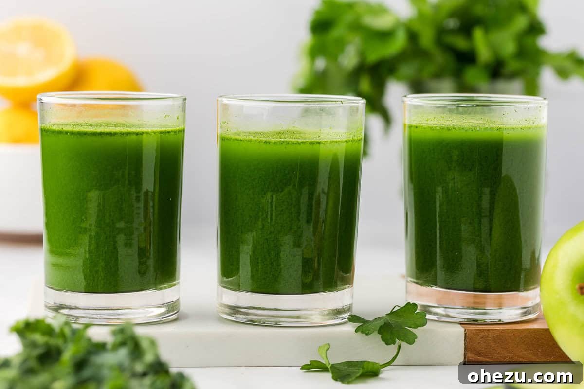 Multiple glasses of vibrant green vegetable juice, ready to be enjoyed