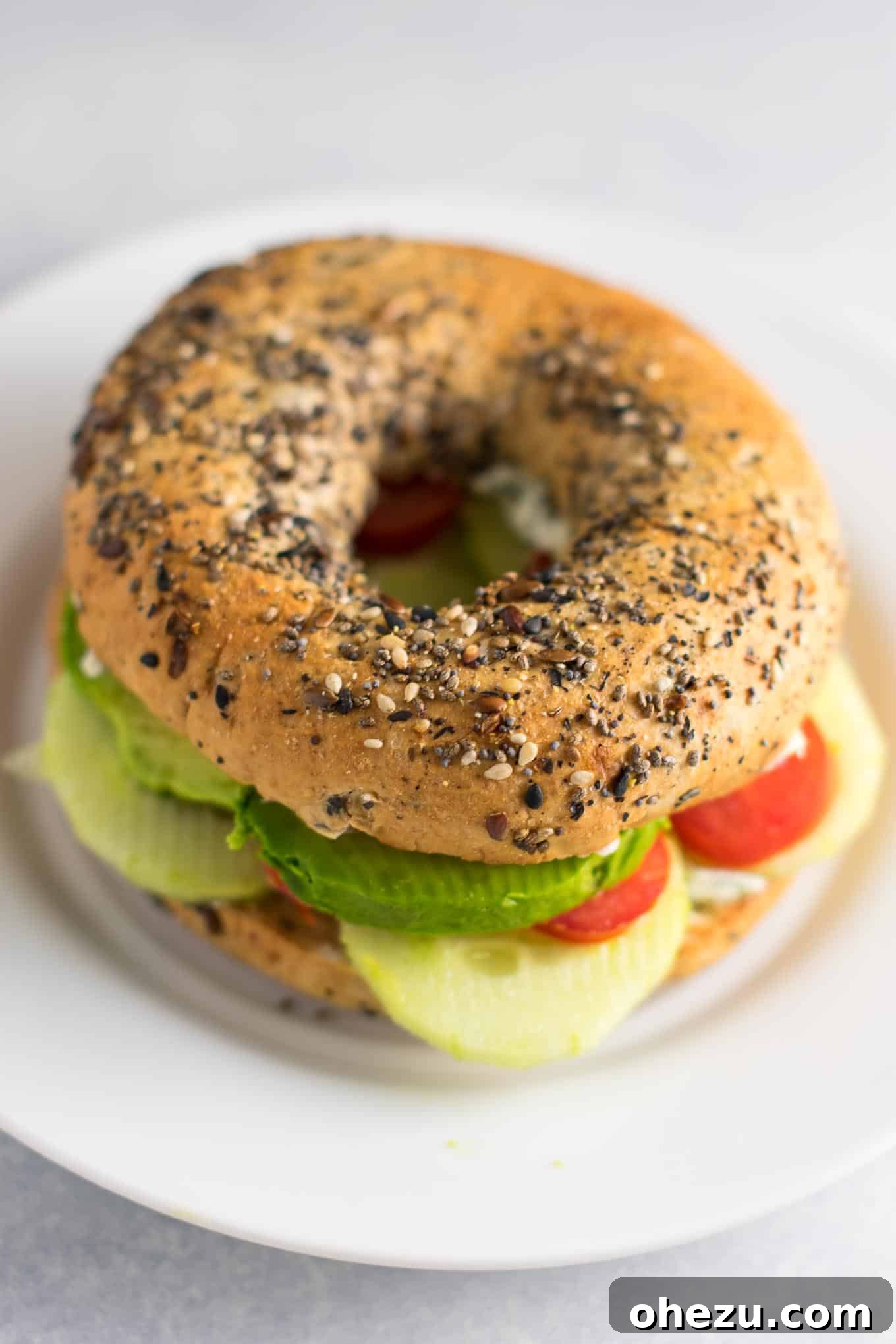 Everything-Spiced Veggie Delights with Garlic Dill Cream Cheese 4 Garlic Dill Cream Cheese spread generously on an everything bagel, ready for toppings