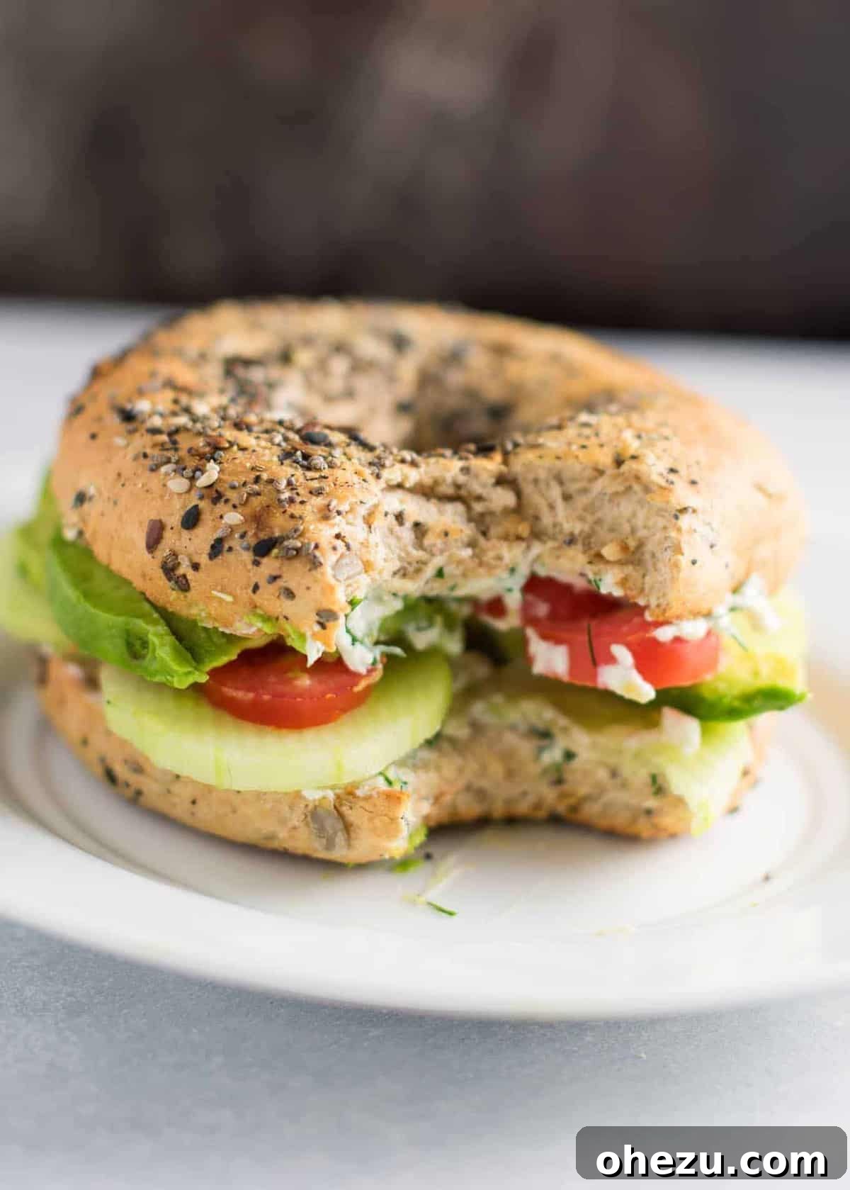 Everything-Spiced Veggie Delights with Garlic Dill Cream Cheese 8 Everything Bagel Veggie Sandwiches with ingredients laid out, emphasizing freshness