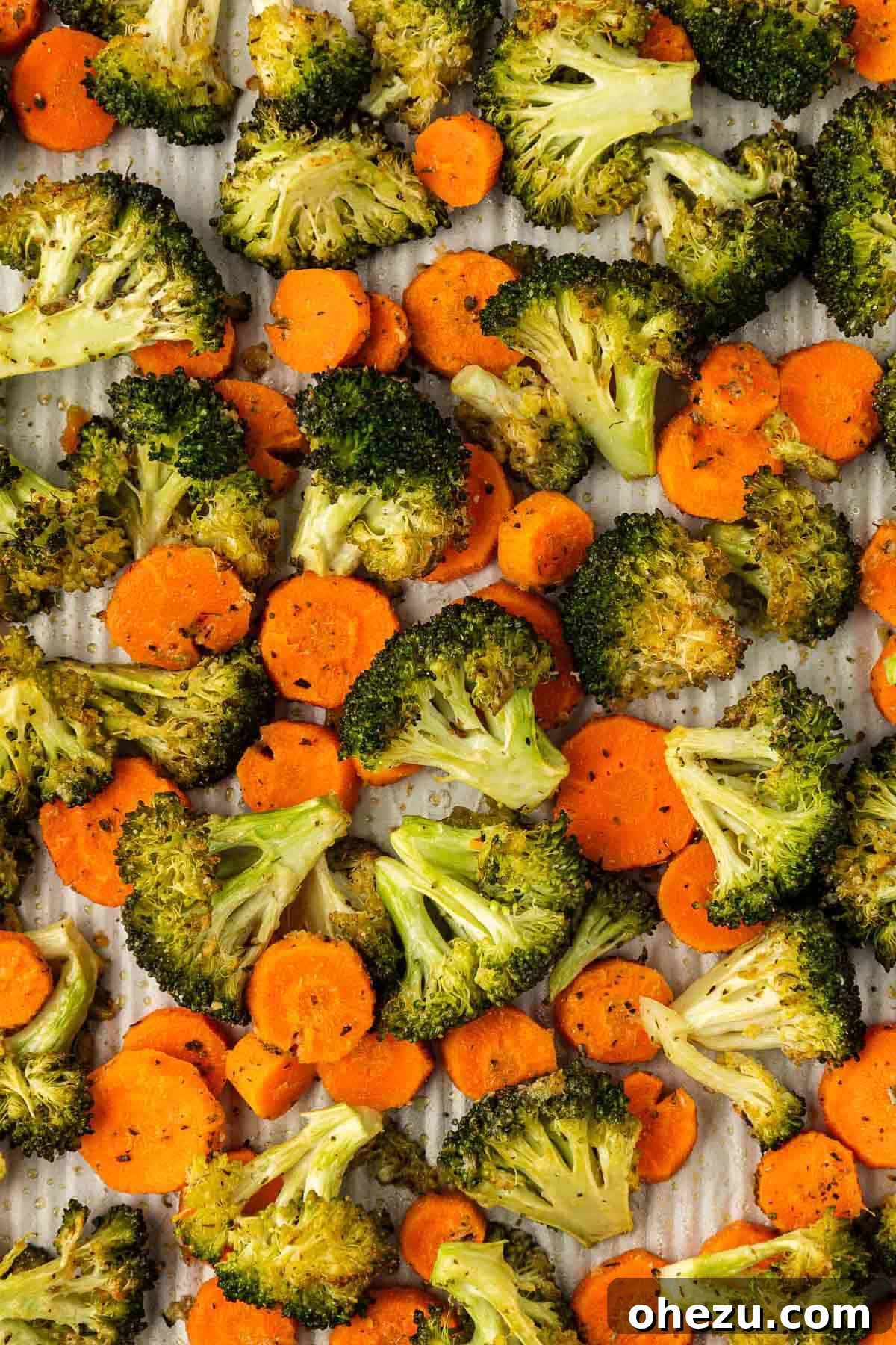 Delicious roasted broccoli and carrots on a baking sheet, fresh from the oven, ready to serve.