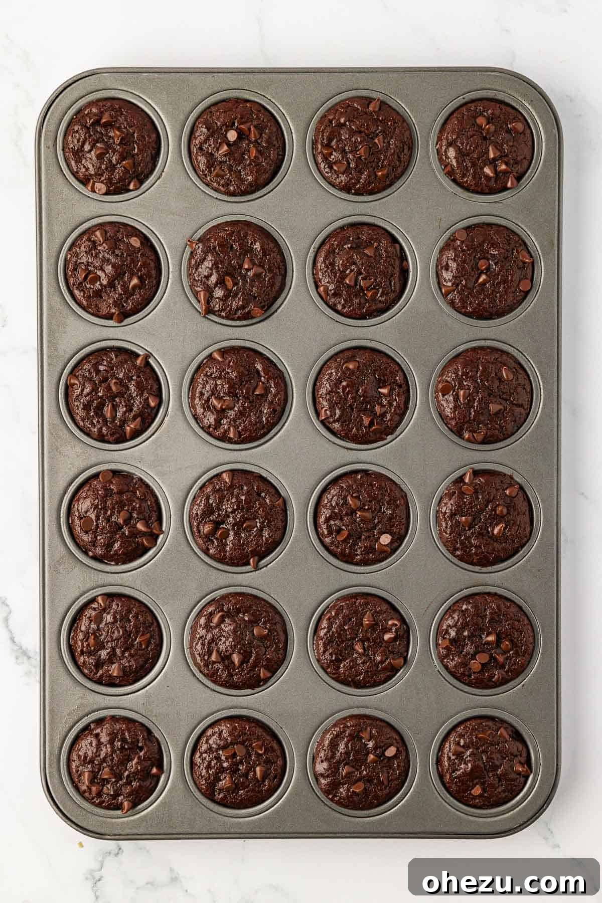 Nourishing Chocolate Mufflets 14 Mini chocolate muffins baking in a muffin tin, rising beautifully and developing golden edges