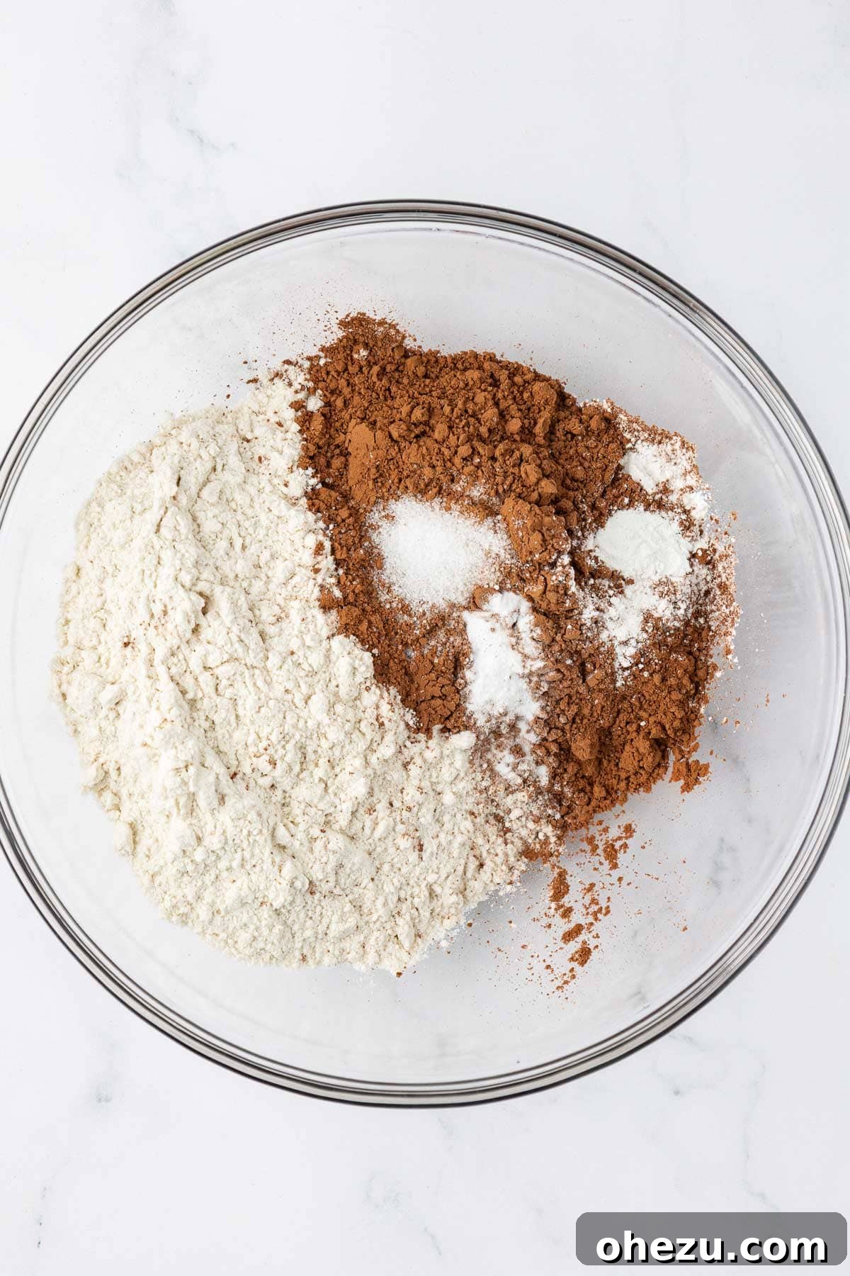 Nourishing Chocolate Mufflets 5 Dry ingredients for muffins in a mixing bowl before whisking, showing separate powders