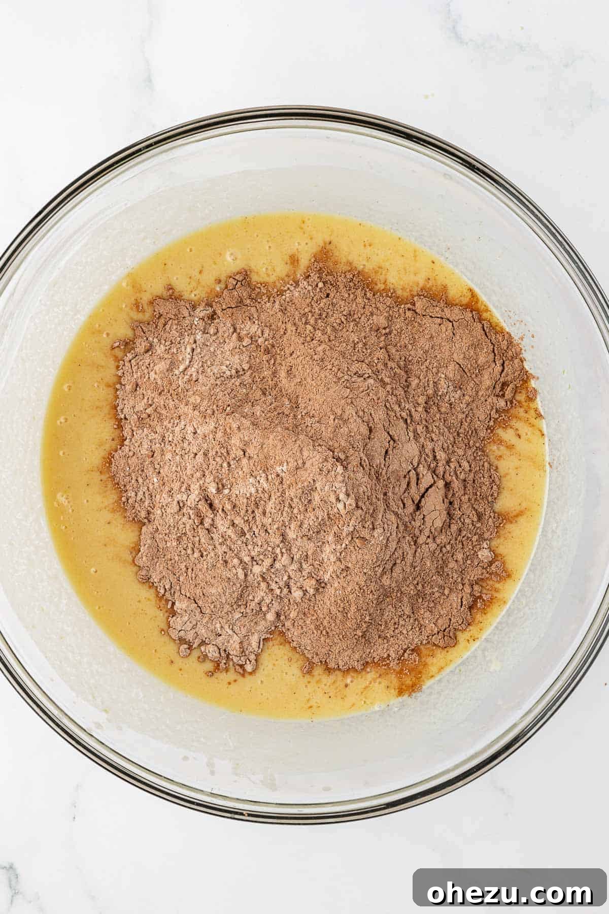 Nourishing Chocolate Mufflets 9 Pouring dry cocoa and flour mixture into the wet ingredients for chocolate muffin batter