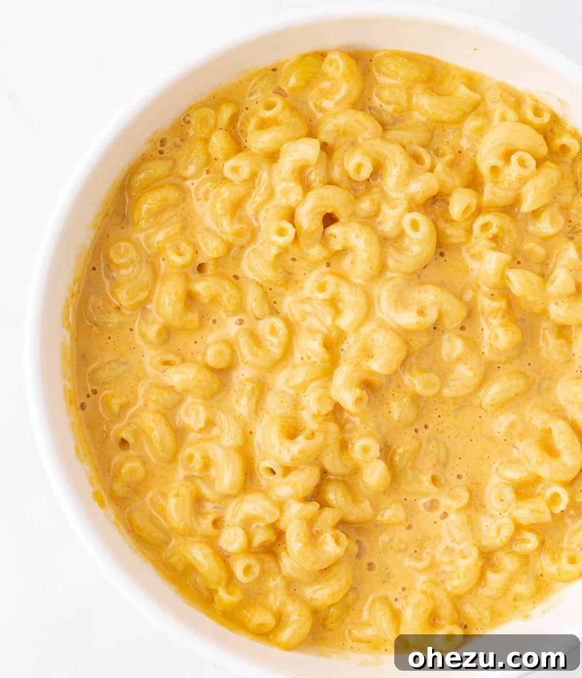 A comforting bowl of butternut squash mac and cheese, garnished and ready for a meal.
