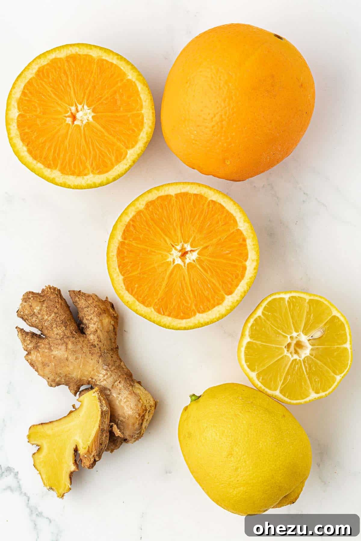 A hand holding a peeled lemon and ginger root, showcasing preparation for juicing.
