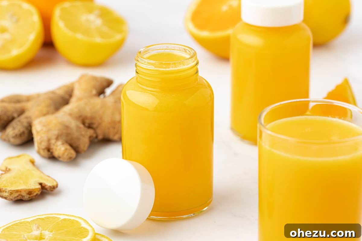Overhead shot of two hands holding a small jar of immunity shot, ready to drink.