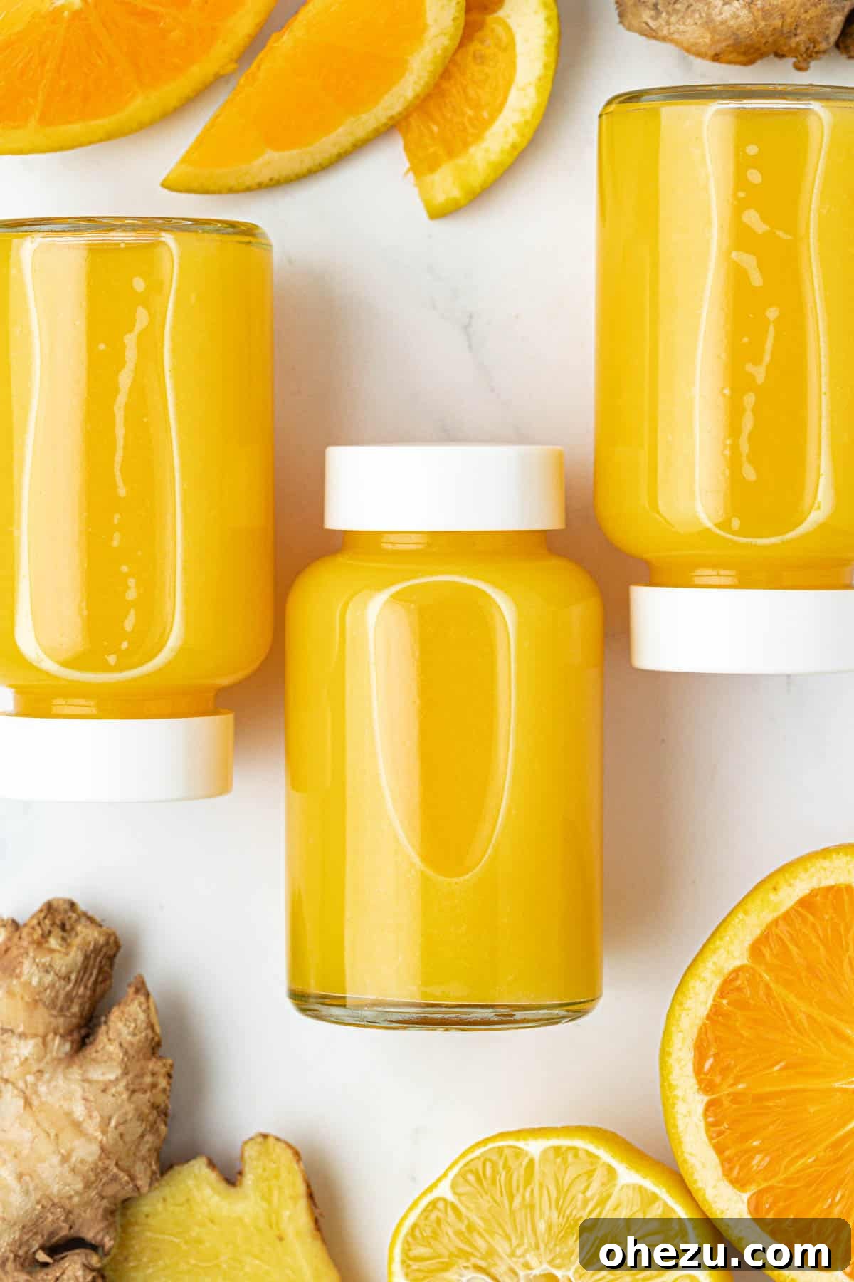 Assortment of fresh citrus fruits and ginger on a wooden table, emphasizing natural ingredients.