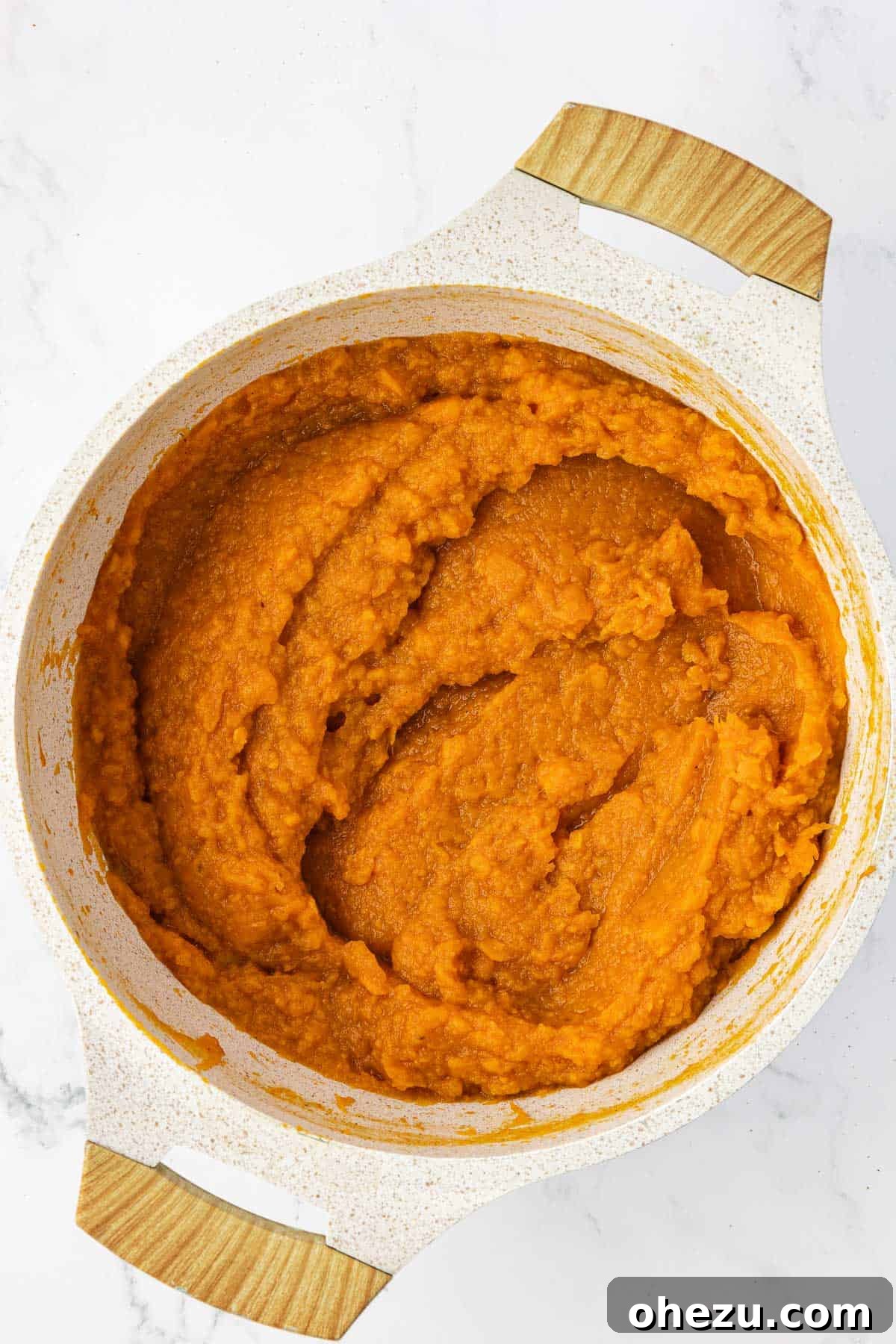The creamy, golden sweet potato filling mixture in a saucepan after all ingredients have been thoroughly combined.