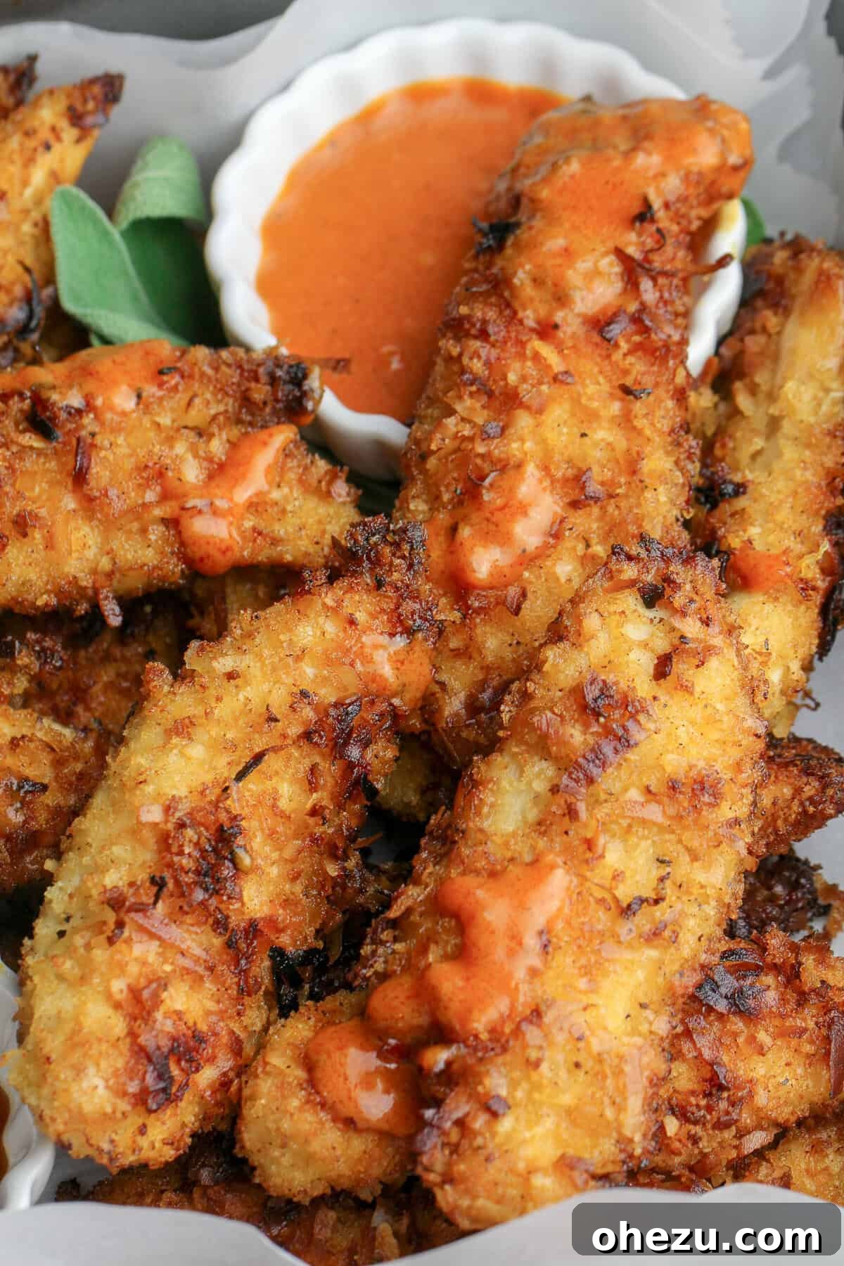 Plated Spicy Coconut Chicken Tenders with fries