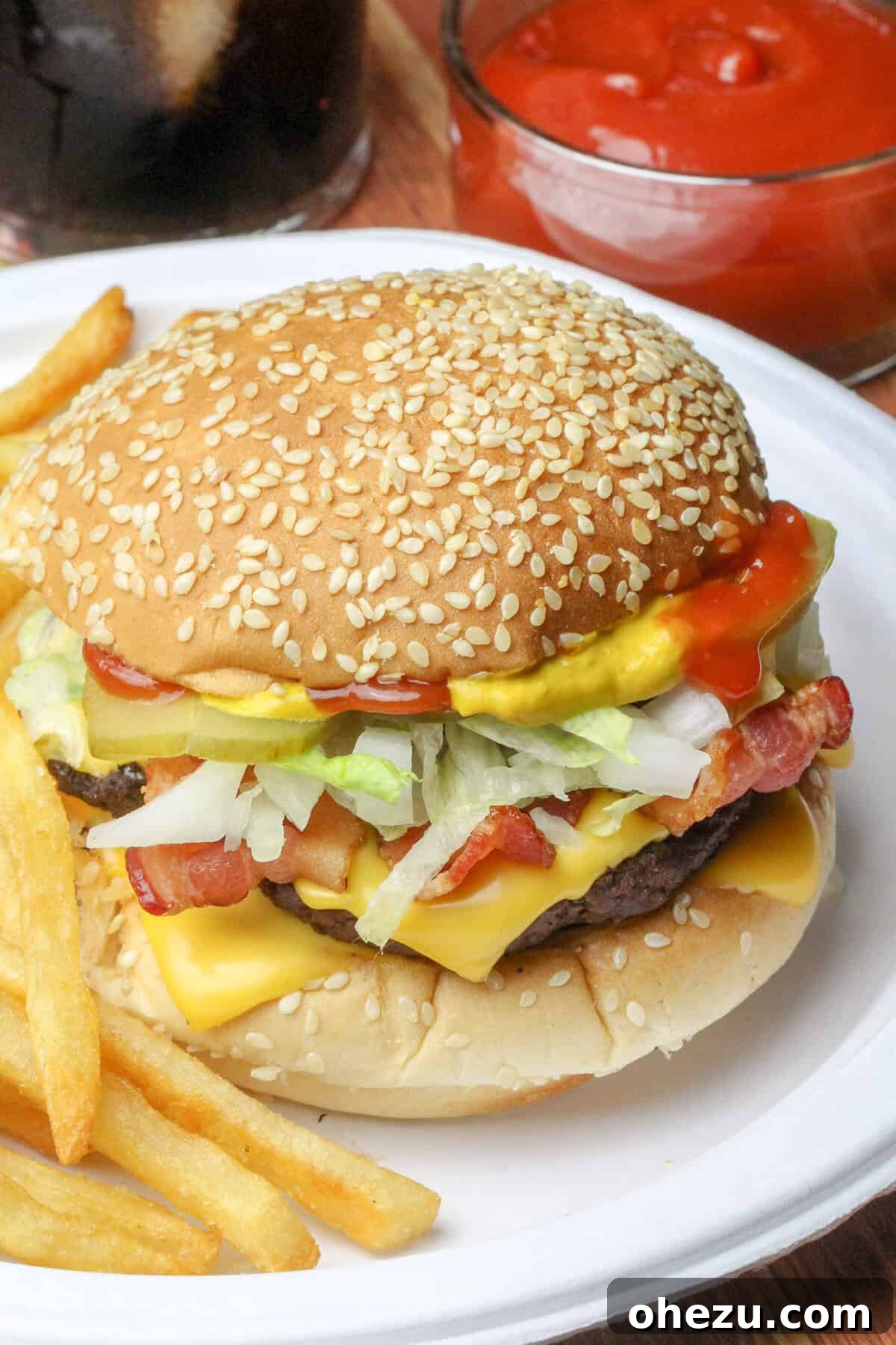 The Ultimate Homemade Travis Scott McDonalds Burger 2 The Travis Scott Burger McDonald's Copycat Recipe - A delicious homemade replica of McDonald's popular celebrity meal, featuring a hearty beef patty, melted cheese, crispy bacon, fresh lettuce, tangy pickles, and savory onions on a soft sesame bun.