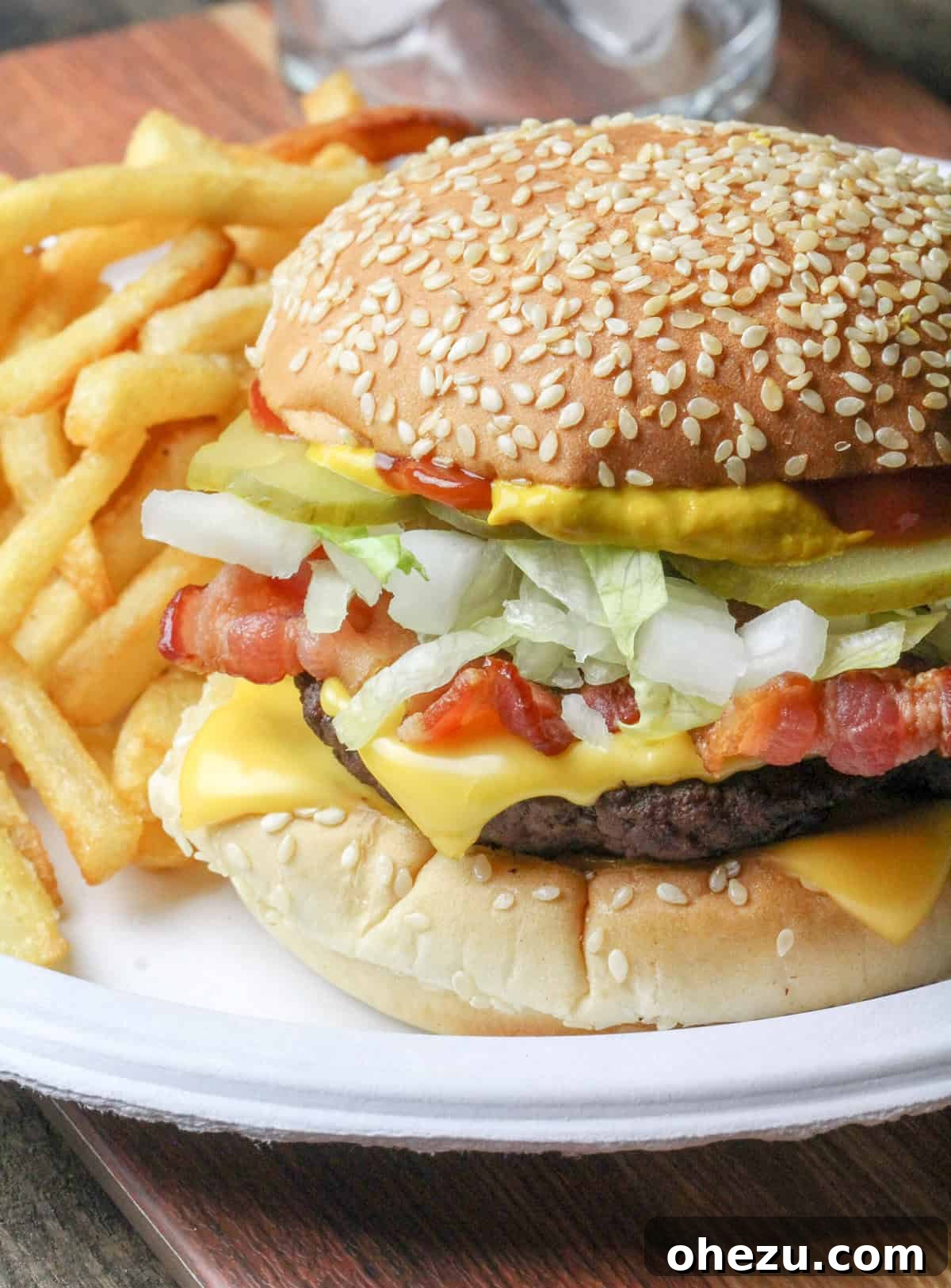 The Ultimate Homemade Travis Scott McDonalds Burger 3 Ingredients for a homemade Travis Scott Burger McDonald's copycat recipe, showcasing fresh beef, American cheese, crispy bacon, shredded lettuce, fast-food style pickles, and chopped onions.