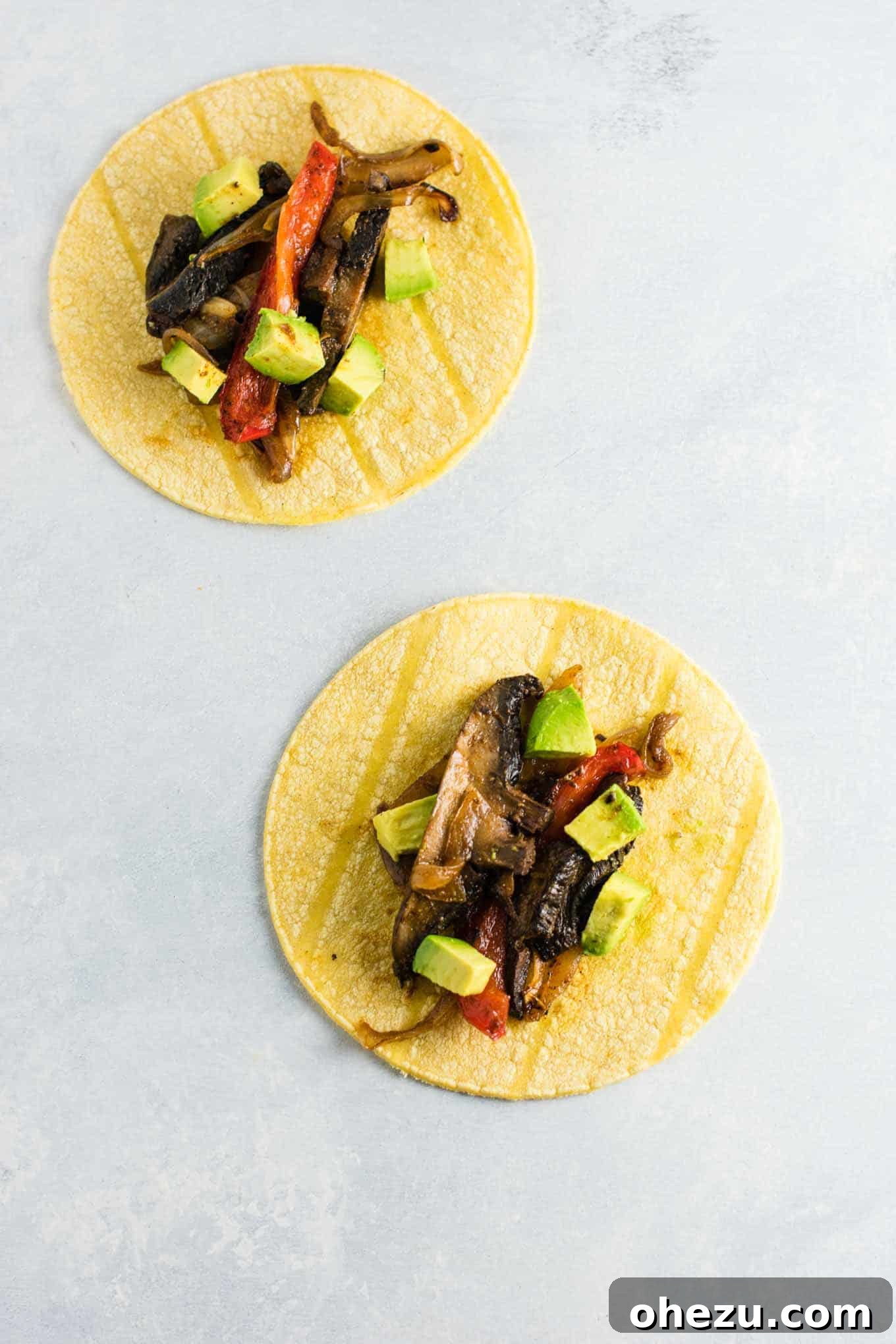 Sizzling Portobello Fajitas 2 Mouthwatering portobello mushroom fajitas on a warm corn tortilla, garnished with fresh diced avocado