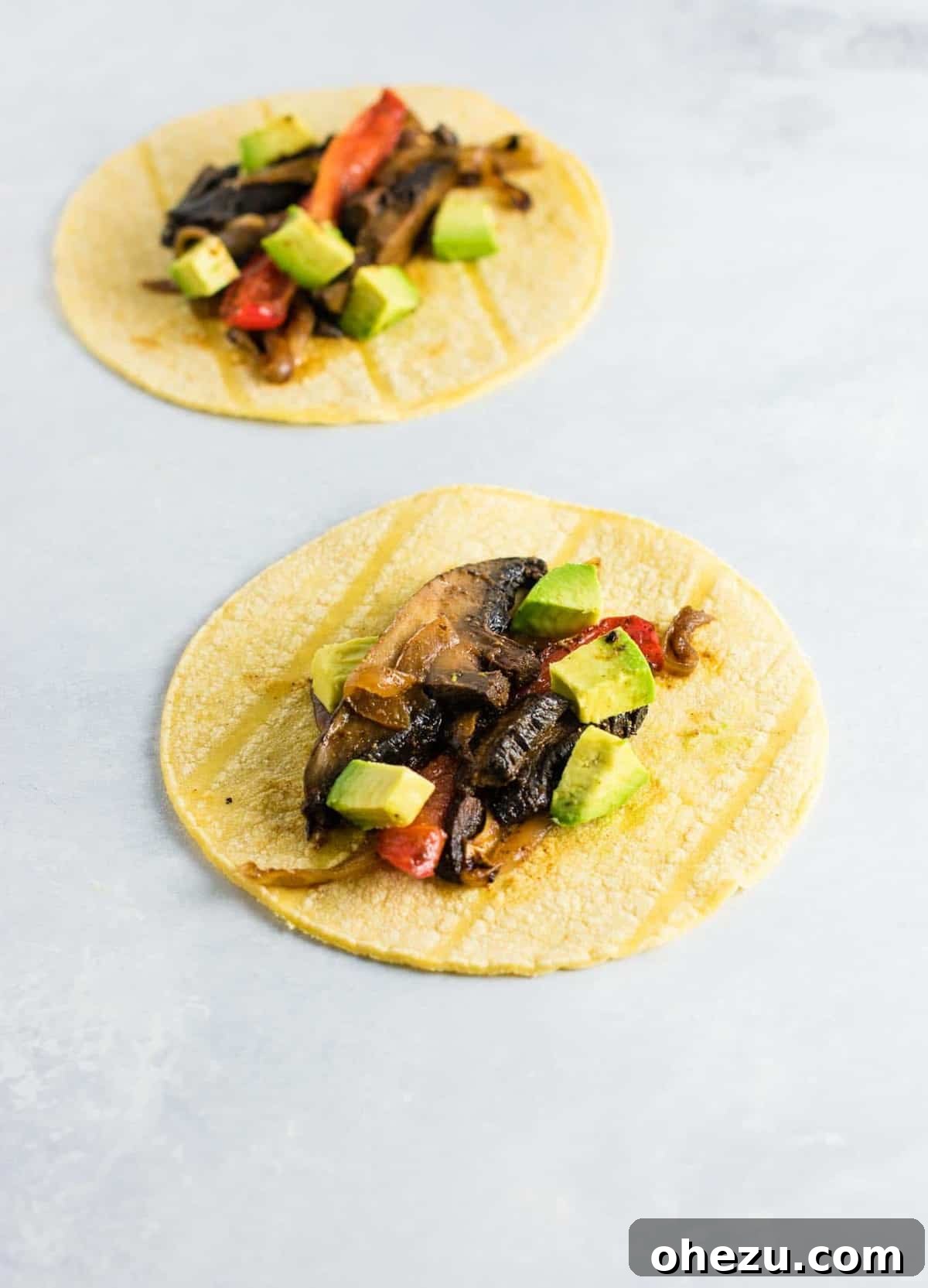 Sizzling Portobello Fajitas 6 Another close-up shot of a portobello mushroom fajita nestled in a warm corn tortilla, highlighting the rich colors and textures